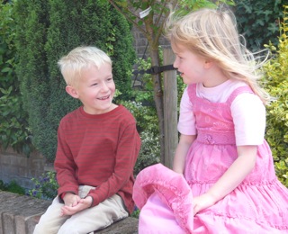 Grandchildren Oliver and Amy on the wall outside our house