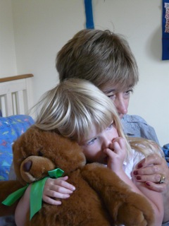 Dot, Amy and bear cuddle up.