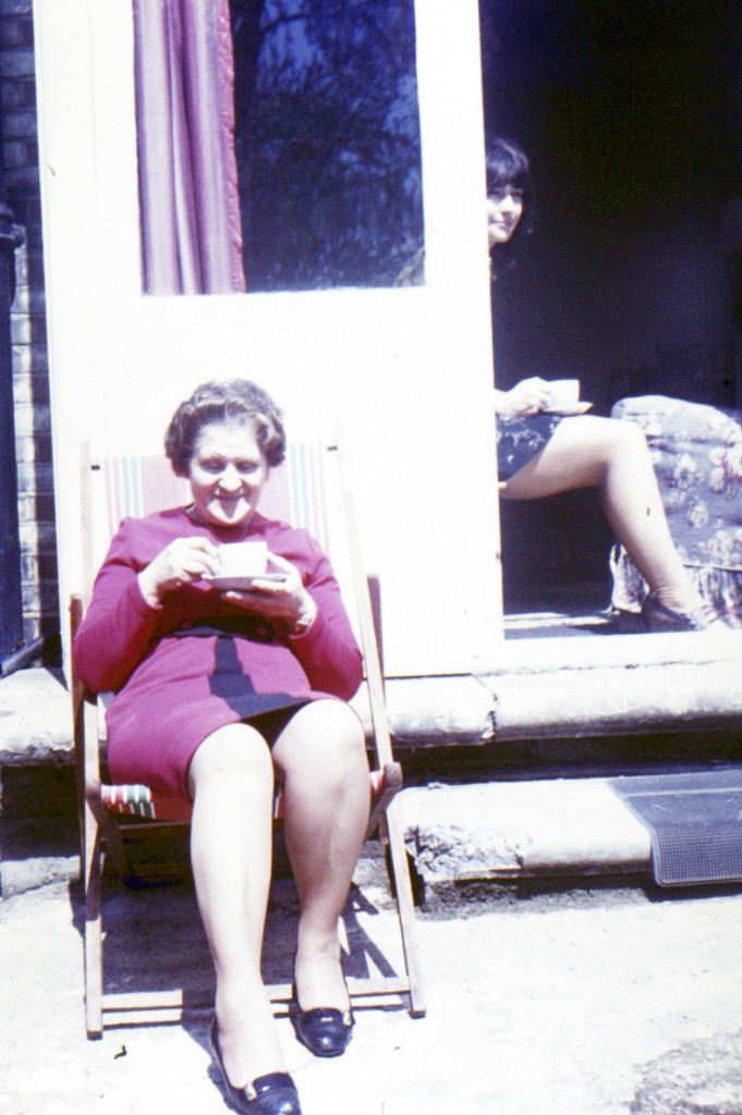 My mother sitting in the sun outside our flat in Fernleigh Road - with Dot in the background. Early 70s.