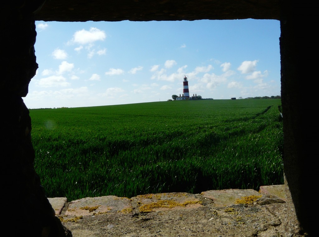 Happisburgh lighthouse from the now accessible pill box near the cliff edge.