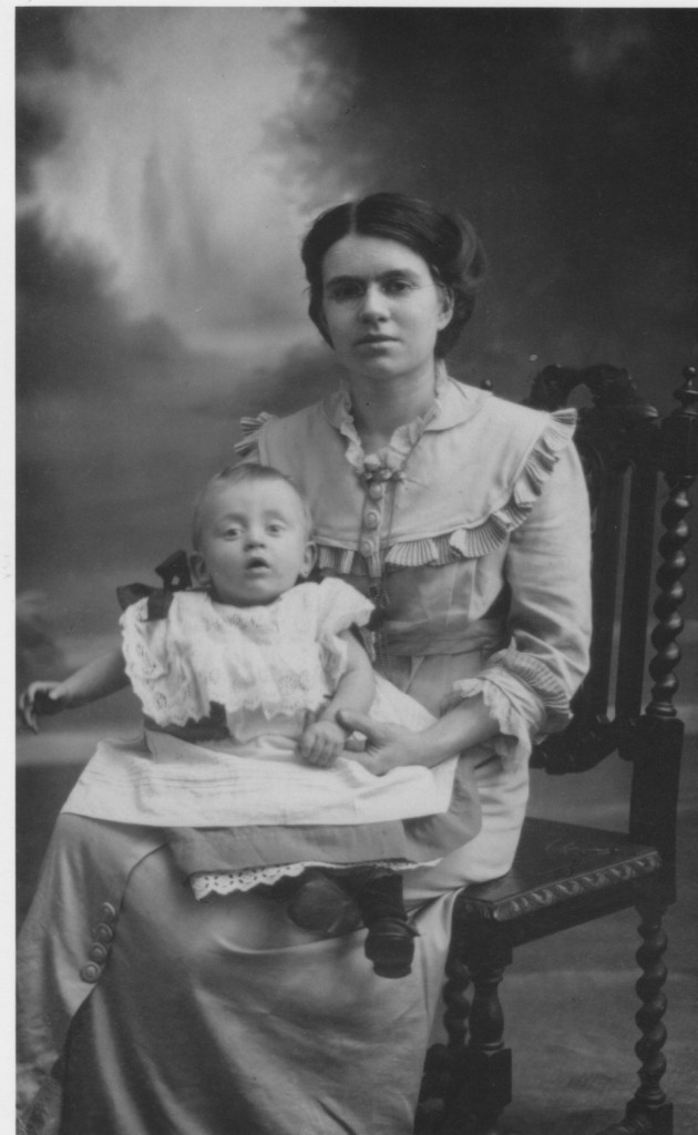Dot's grandmother Emma with Dot's father Oliver on her lap.