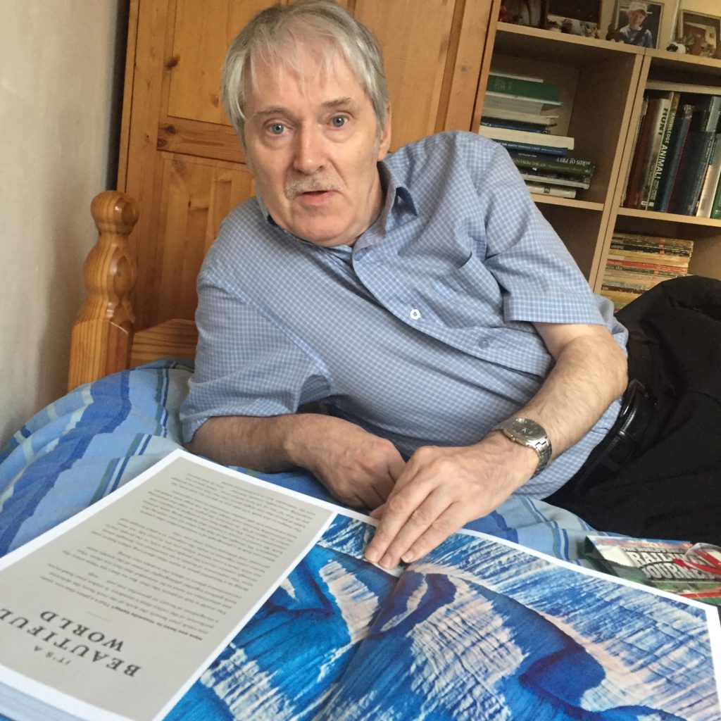 Andrew in his room just after Christmas, looking at a book we took for him.