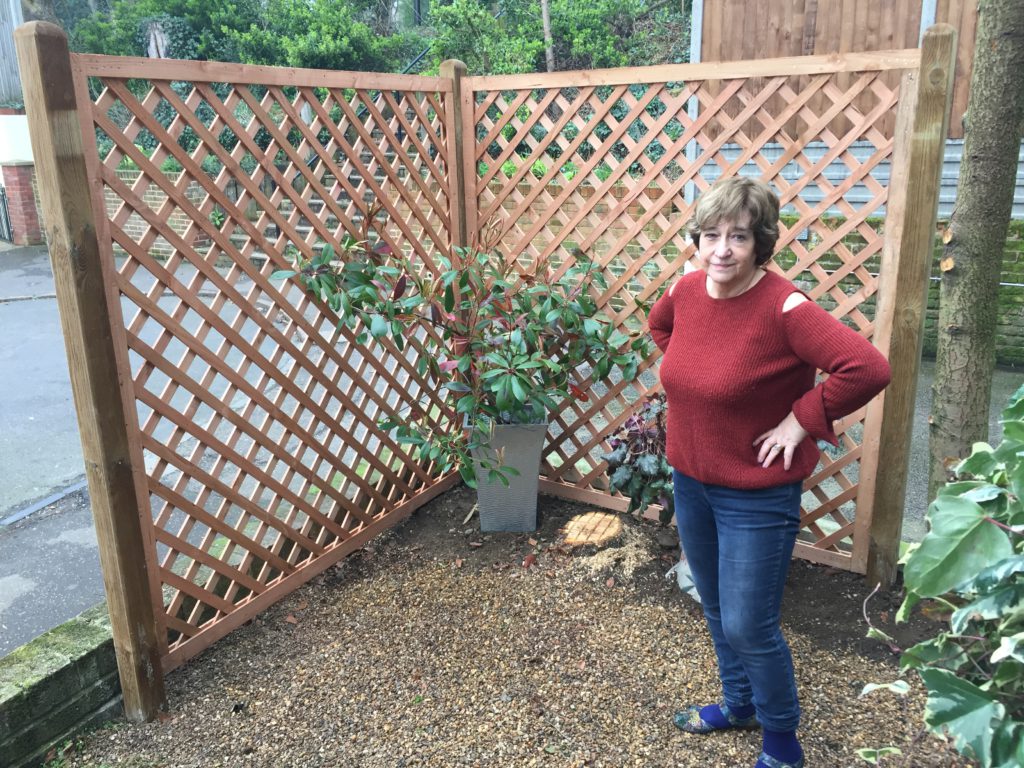 Dot as proud owner of some new trellis work, with manky trees removed.