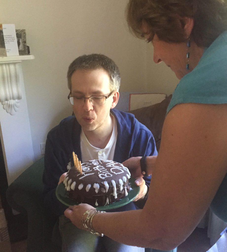 David successfully blows out all the candles on his birthday cake.